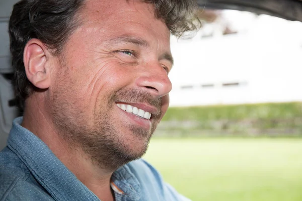 Happy man driver in car or van on road trip — Stock Photo, Image