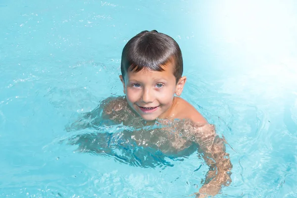 Cheerful kid boy in pool in home — Stock Photo, Image