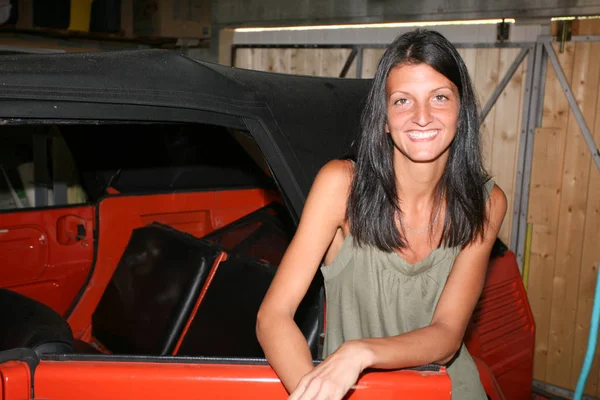 A cheerful girl with old orange vintage car — Stock Photo, Image