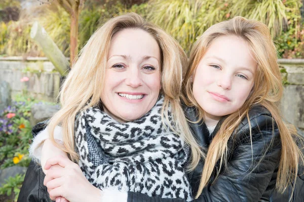 smiling women family with blond daughter and mother