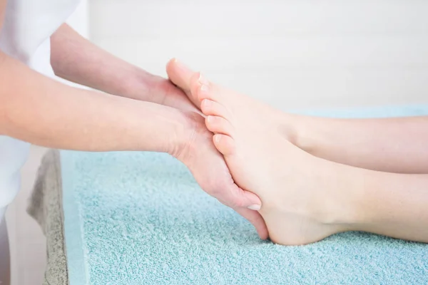 Massage of human foot in health spa salon
