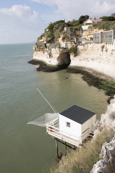 typical landscape fishing cabin on a sea pier with a net at Talmon in the Gironde estuary in West coast of France