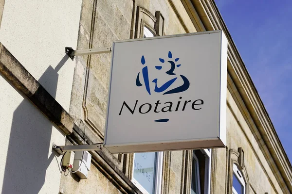 Notaire sign logo french on wall above entrance to the notary office
