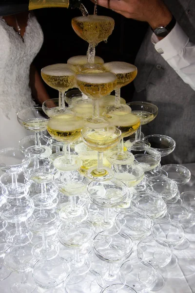 champagne glasses tower on the table at a wedding