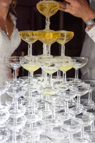 champagne glasses standing in pyramid tower at wedding bride groom party