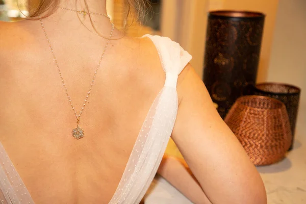 necklace behind on the woman bride back neck rear wedding day at home
