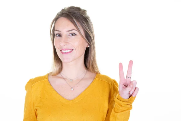 Young Woman Yellow Sweater Isolated White Background Smiling Showing Victory — 스톡 사진
