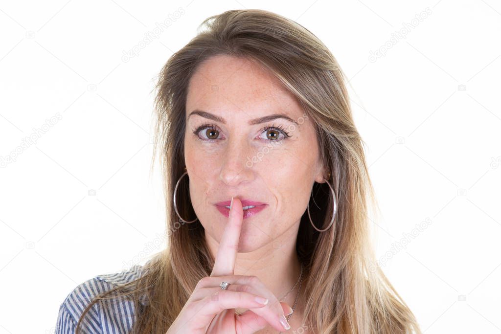 beautiful woman with long blonde hair shows shh hush sign asks not to tell secret anybody hopes loyalty silence