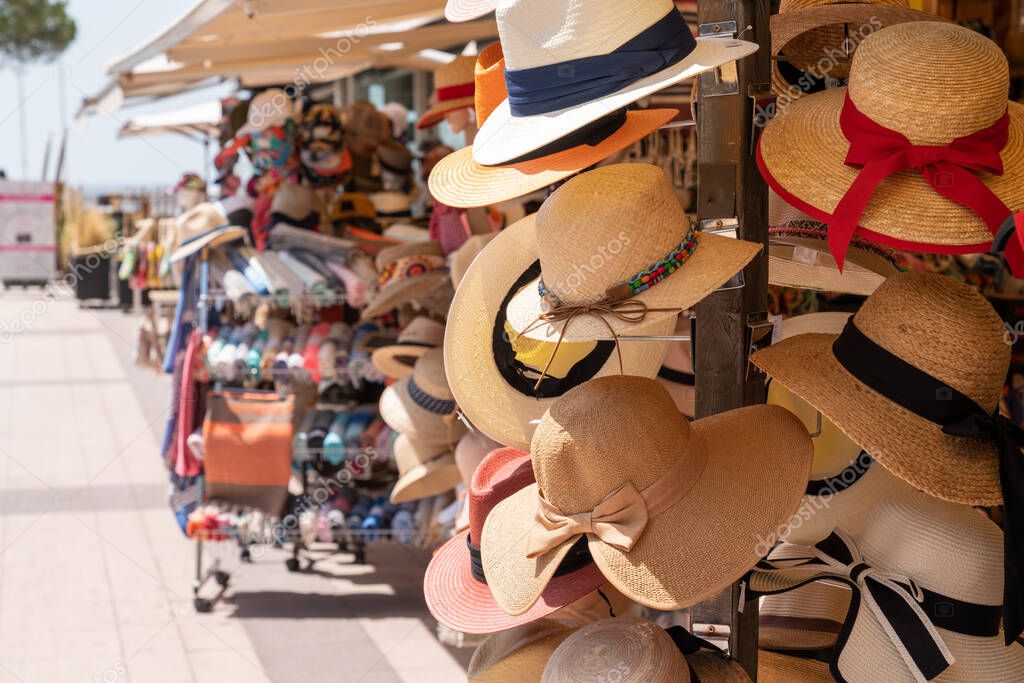 Touristic street market selling souvenirs like straw hat
