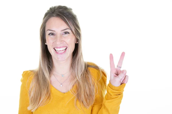 stock image Happy young blonde woman showing v victory peace sign