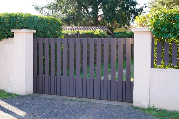 Metal driveway entrance gates house garage in suburb