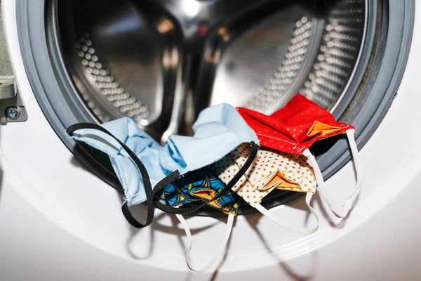 Coronavirus 'u temizlemek için çamaşır makinesinde ev yapımı birkaç maske.