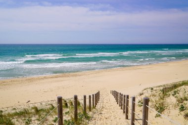 path access dune sand beach of la jenny in atlantic ocean France clipart