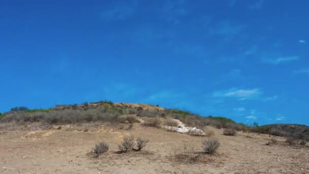 White painted stones arranged to form letter V on Ventura mountain. — Stock video