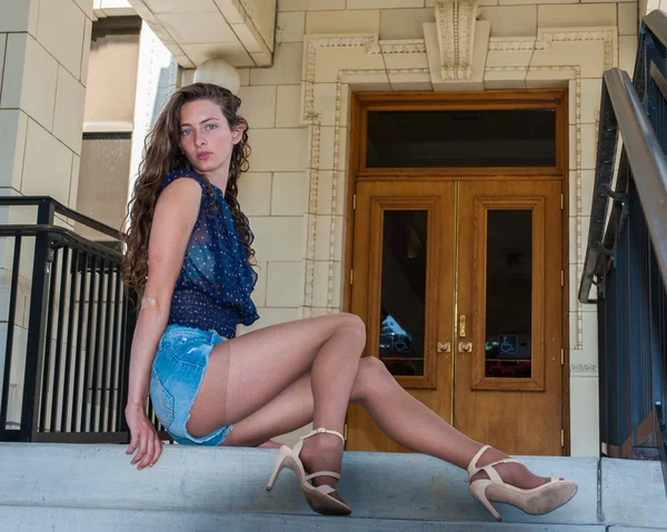 Cropped image of female legs in beige pantyhose and denim jeans standing  straight Stock Photo - Alamy