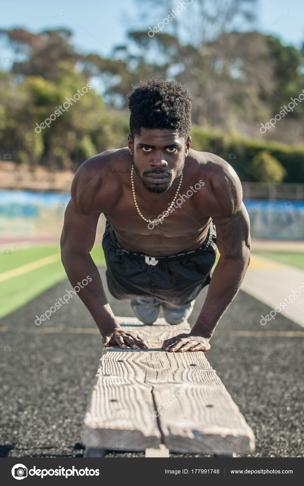 Muscular Jamaican Athlete Performing Push Bench Bulging Triceps