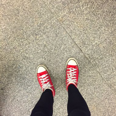 Kız bacaklar toprak zemin üzerine kırmızı spor ayakkabılar 