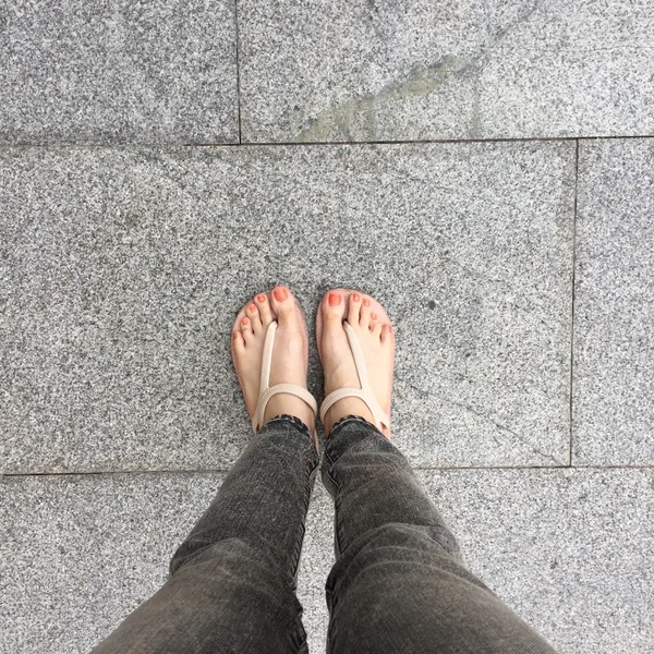 Woman Legs and Feet Stand on the Ground