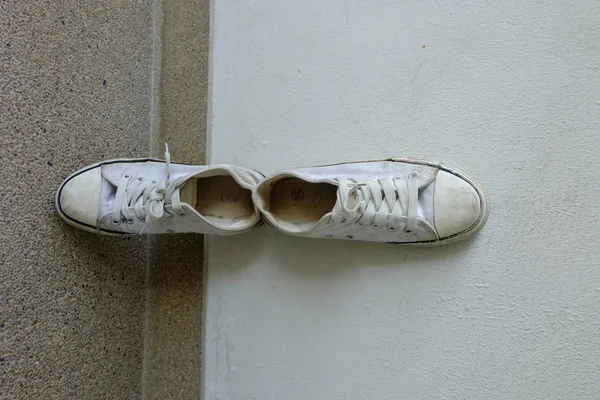 Vintage shoes, White Sneakers on Floor Background