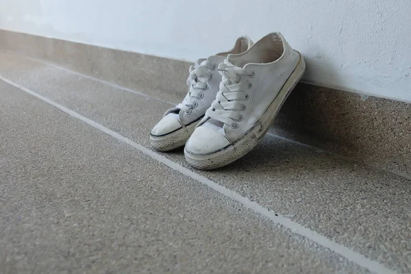 Vintage shoes, White Sneakers on Floor Background