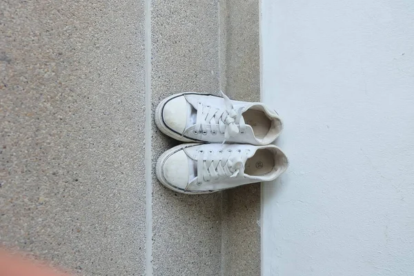 Vintage shoes, White Sneakers on Floor Background