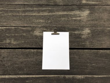 Ciltçi klibini ve ahşap arka plan üzerinde kağıt yığını