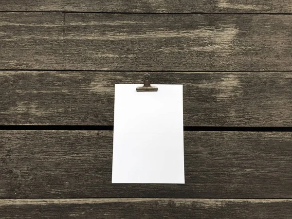 Ciltçi klibini ve ahşap arka plan üzerinde kağıt yığını