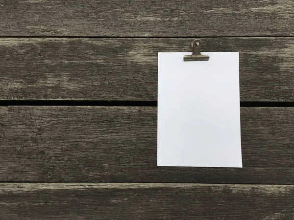 Ciltçi klibini ve ahşap arka plan üzerinde kağıt yığını