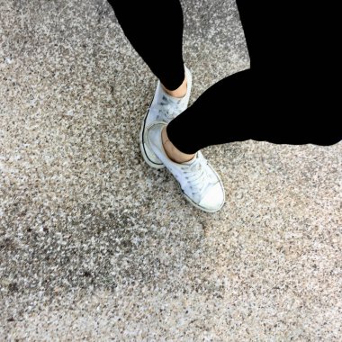 Genç moda kadının bacakları ile spor ayakkabı, kat arka plan üzerinde beyaz Ayakkabı