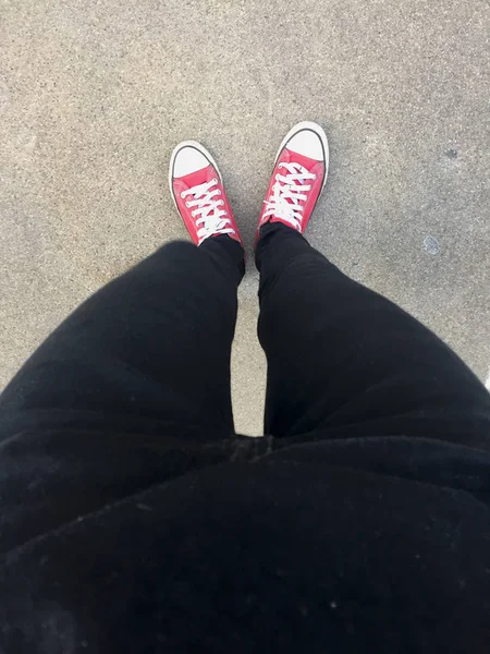 Feet From Above Concept, Teenage Person in Red Sneakers Standing on Ground Background — Stock Photo, Image