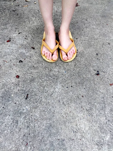 Yellow Sandals on Female Feet on Ground Background — Stock Photo, Image