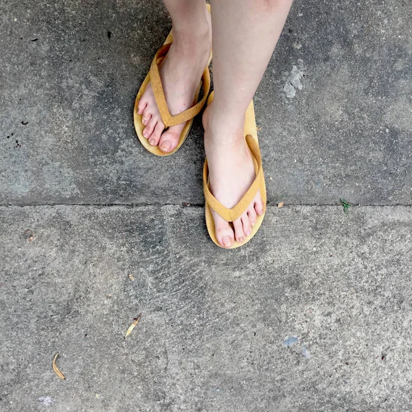 Yellow Sandals on Female Feet on Ground Background — Stock Photo, Image