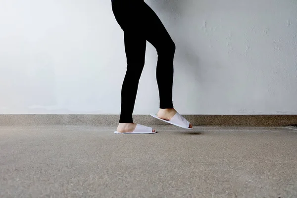 Closeup Photo of From Woman Wearing White Slippers and Black Pants — Stock Photo, Image