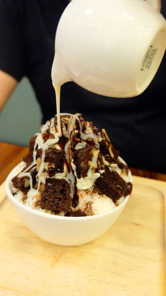 Snow Ice Flake Dessert Topping with Chocolate and Sweet Sauce, A Bowl of  Bingsu Ice Dessert on Wood Table