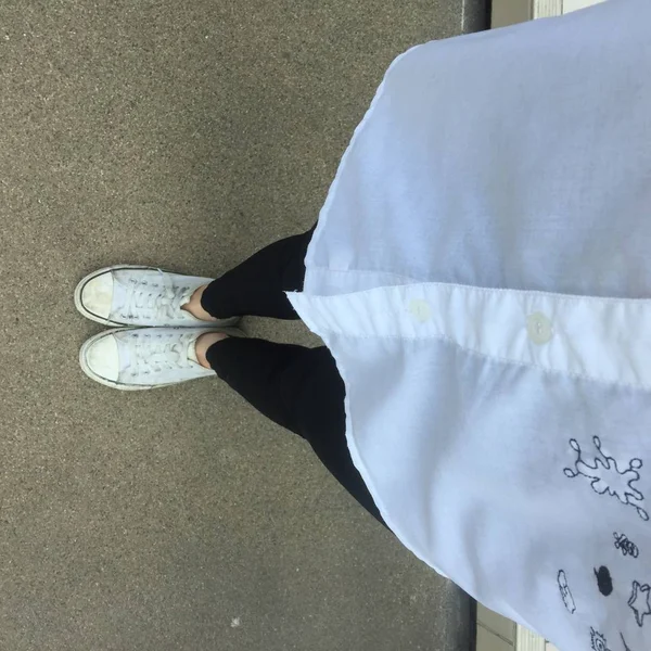 Фотография крупным планом женщины в белых кроссовках на улице — стоковое фото