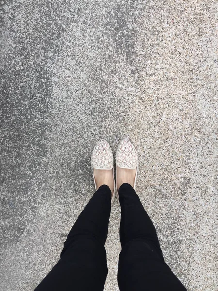 Close Up Of Girl 's Feet Wearing Sandals In The Ground — стоковое фото