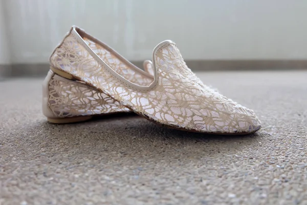 Closeup Photo of  Weave Sandals Shoes on Concrete Floor Background