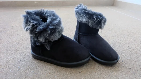 Female Winter Fur Boots or Shoes On The Concrete Floor Background — Stock Photo, Image