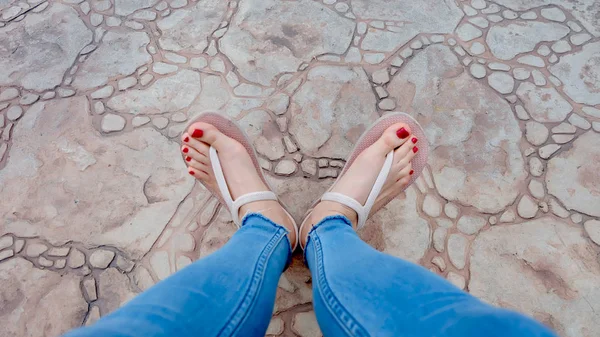 Close Up sui piedi della ragazza indossando sandali e Blue Jeans sulla piastrella — Foto Stock
