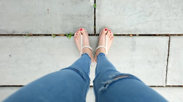 Close Up on Woman 's Feet Wear Sandals on The Concrete — стоковое фото