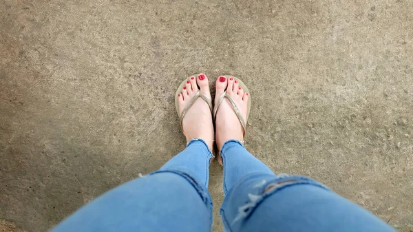 Mujer con sandalias en el piso de hormigón — Foto de Stock