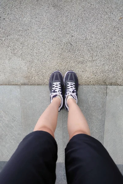 Sport Violet Sneakers, Young Female of Running Shoes on The Cement background — стоковое фото