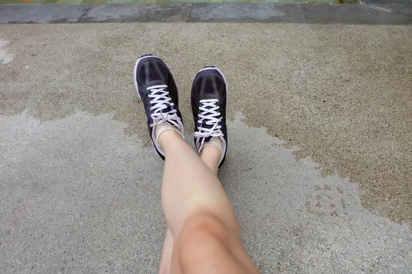 Sport Violet Sneakers, Young Female of Running Shoes on The Cement background — стоковое фото