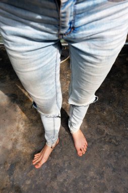 Barefeet Selfie eski beton zemin üzerine mavi kot pantolon giymek