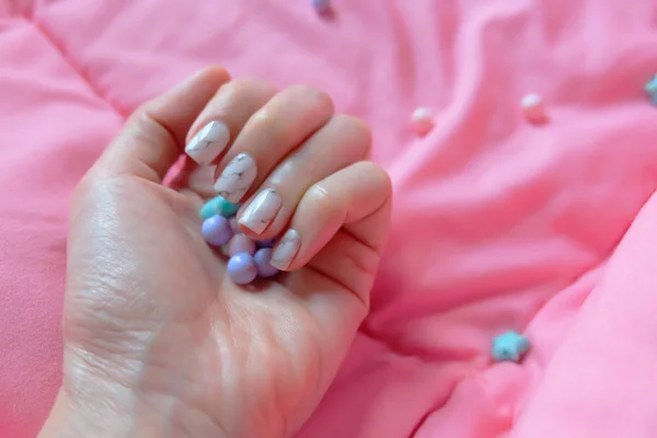 Granite Gray Nail. Tutup Kuku Polandia dengan Bead Berwarna di Latar Belakang Blanket Merah Muda — Stok Foto