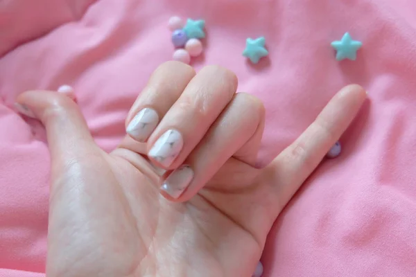 Granite Gray Nail. Close Up Nails Polish with Colourful Bead on Pink Blanket Background — Stock Photo, Image