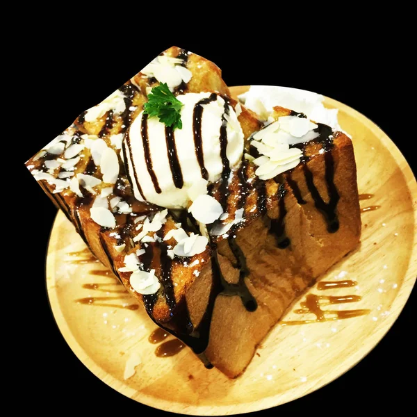 Медовый хлеб, ванильное мороженое и шоколадный десерт на фоне деревянной плиты — стоковое фото