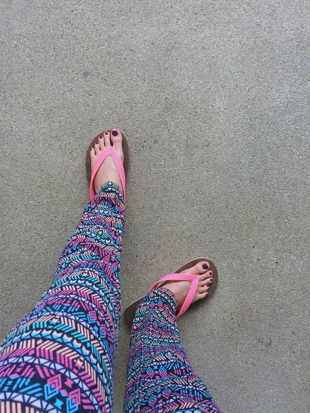 Sandal, Close Up on Girl\'s Violet Nail and Feet Wearing Pink Sandals on the Street Background