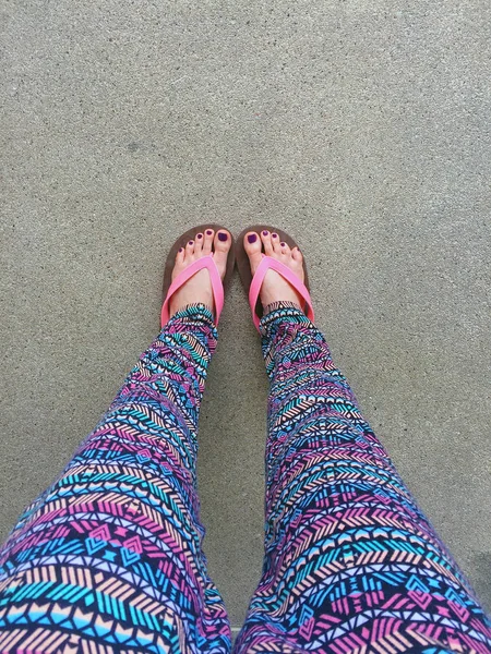 Sandal, Close Up on Girl\'s Violet Nail and Feet Wearing Pink Sandals on the Street Background