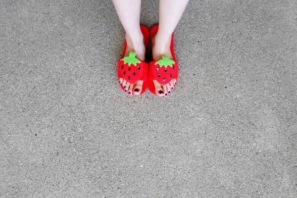 Close Up Woman's Feet Wearing Sandals Strawberry with Violet Nail on Cement Background